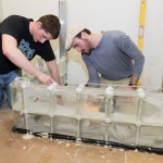 Ciaran E. Cahalane (left) and DiBucci lay another course of block.