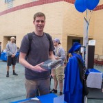 Jarred T. Barch, of Reading, enrolled in information technology: network specialist concentration, claims the attire he won in a giveaway. (Let's hope the gown is long enough for the 6-foot-9-inch graduate-to-be!) 
