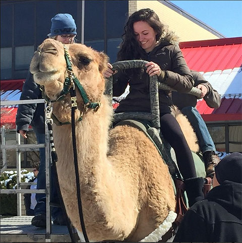 Enjoying an encounter not usually associated with northcentral Pennsylvania, pre-dental hygiene major Alexandra D. Petrizzi, of Langhorne, takes the camel for an apres-snowstorm stroll. 