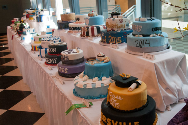 Students in the Cakes and Decorations course skillfully fill a table with graduation-themed cakes.