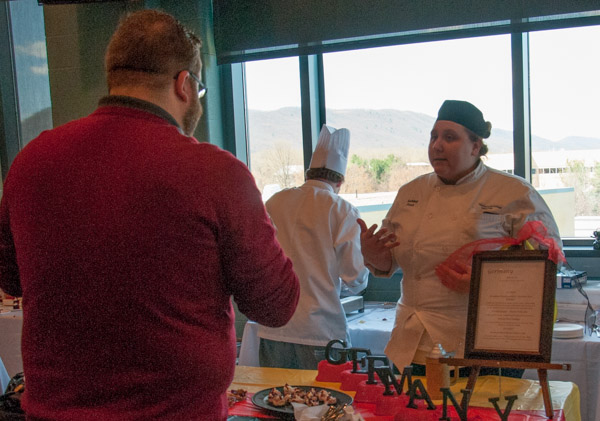 Ashley R. Post, of Orwigsburg, explains to judge Christopher R. Grove, a Penn College dining services manager, why she and Zachary A. Mausteller, of Danville, chose a German menu.