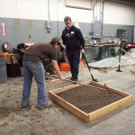 Students in the hardscape competition prepare the base for brick pavers.