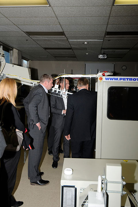 Visitors get a look at blow-molding machinery ...