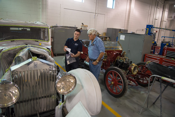Hunter shows Leno some of the metallurgy research the students have conducted on the Rolls Royce. 