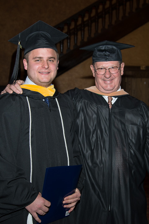 Friday's student speaker, is encouraged by John M. Young, a member of the college's board of directors.