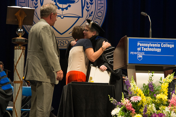 Joseph H. and Barbara A. Reynolds receive the president's profound congratulations on accepting their alumni Humanitarian/Citizenship Award.