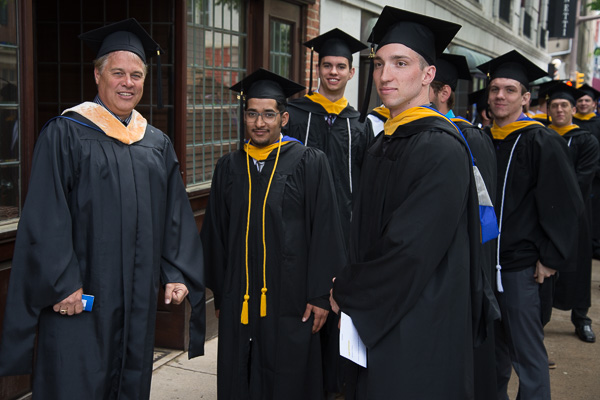 Todd S. Woodling (left), assistant professor of building automation technologies, prepares to lead his former students into the auditorium.