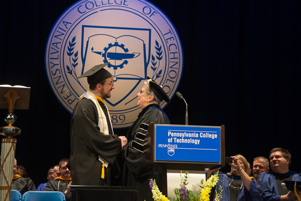 Saturday morning's final graduate, class representative Manley, gets a sincere presidential sendoff.