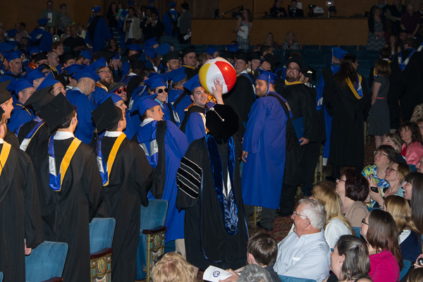 The president sends a beach ball back into play during her recessional from the theater.