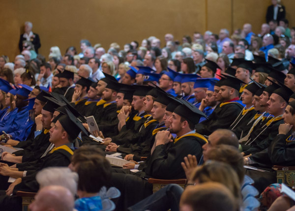 Friends and family envelop the graduates, physically and emotionally.