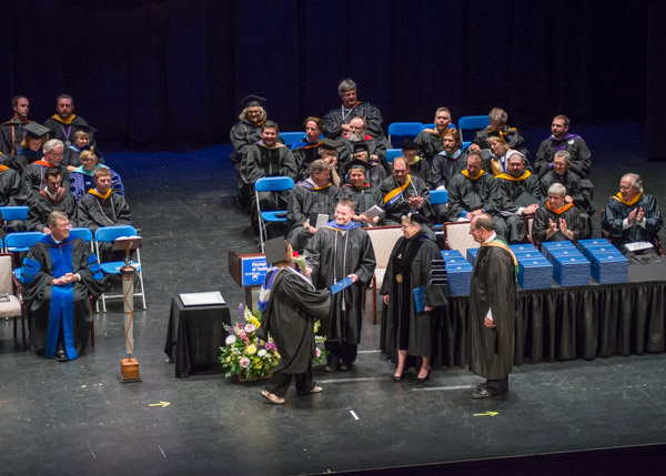 Annette M. Counterman, of Milton, is presented with her diploma by her husband, Arthur L., an instructor of electrical technology/occupations.