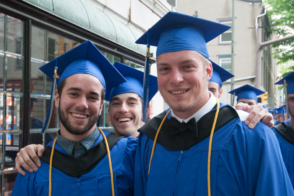 Three grads pause for a photo during the Saturday morning procession.