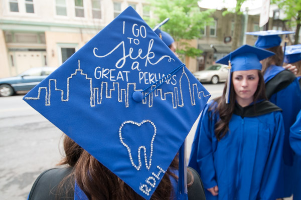A graduate’s mortarboard testifies to her next chapter.