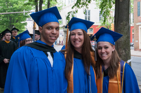 Graduates of the legal assistant-paralegal major stop on their way to the Community Arts Center.