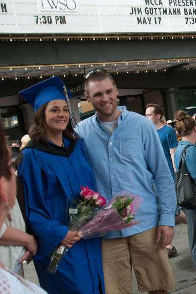 Outshining the Community Arts Center’s future headliners, a couple poses for photos before the marquee.