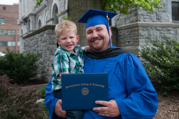 A picture of Penn College pride, as father and son celebrate.