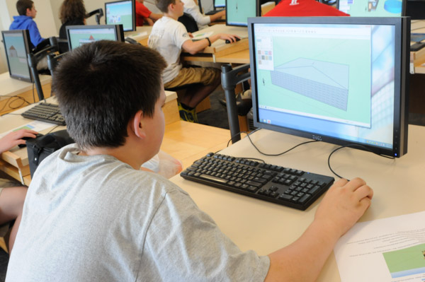 A student uses SketchUp, a free 3-D computer modeling program, to design a house in an architecture lab.