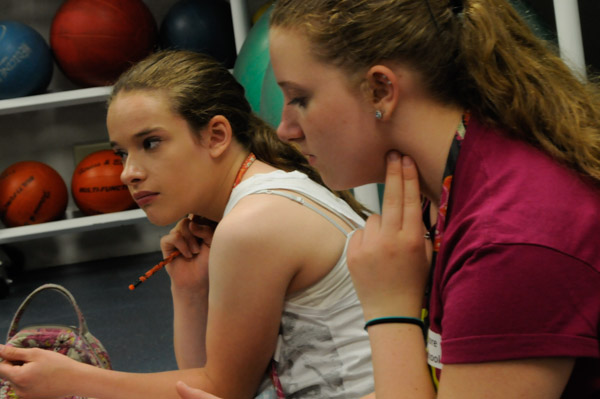 Middle-schoolers determine their resting heart rates during a hands-on workshop that teaches them to take health and fitness assessments, an important skill in exercise science.