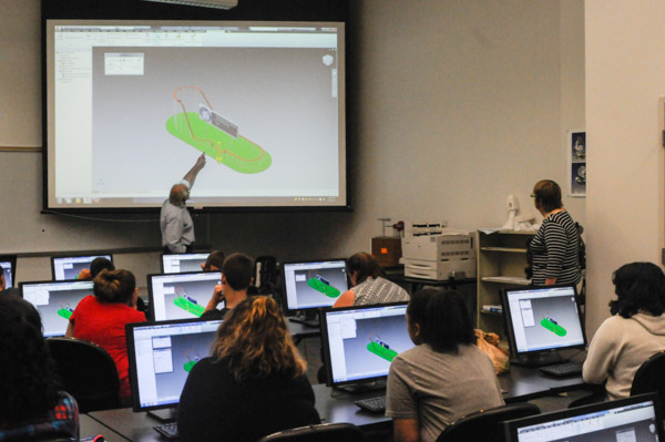 Dave Probst, assistant professor of drafting and computer-aided design, leads students in designing “The Wildcat,” a fictional roller coaster.