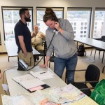 Richard A. Knecht (background), director of Lycoming County Emergency Management Agency, watches as students Christopher H. Warney, of Williamsport, and Jamie L. Steer, of South Williamsport, take action.