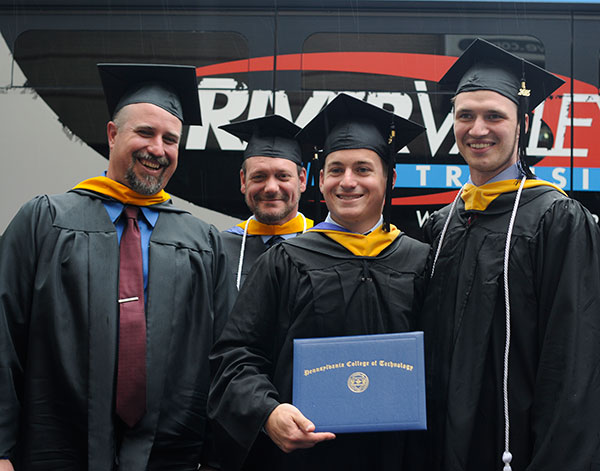 From left, building construction technology instructors Levon A. Whitmyer and Barney A. Kahn IV celebrate with new grads (and Penn College Construction Association members) Vincent S. Del Monte, of Berlin, New Jersey, and Mark A. Lapszynski, of Kennett Square. 
