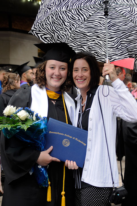 Sheltered from the spring storm are archery standout Kendel F. Baier, of Jersey Shore, with her proud mother, Valerie A., administrative assistant to the president. Baier, who earned a degree in building science and sustainable design: architectural technology concentration, is pursuing a master's degree at the University of North Carolina-Charlotte.