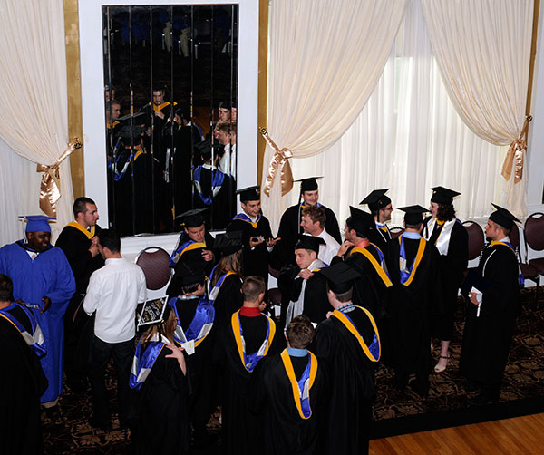 White-shirted members of the architectural technology faculty – Naim N.Jabbour (left) and Daniel L. Brooks – are surrounded by cheerful and grateful students.