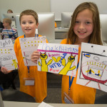 Campers show off some of the artwork they created for the storybooks they produced in print and digital formats. 