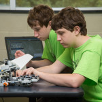 Young campers learn how to program simulation on a Lego robot.