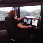 Pamela Mix, secretary to the ESC executive director and assistant dean of transportation and natural resources technologies, takes the wheel of the simulator.