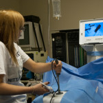 A camper uses a laparoscopic camera and surgical tools in the surgical technology lab.