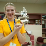 A camper shows the results of her work in the dental hygiene lab: a model of her teeth.