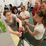A participant shows her team’s solution to a broken camera tripod.