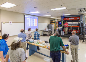 Christopher J. Gagliano (in front of equipment), program manager for the PIRC’s Thermoforming Center of Excellence at Penn College, leads a lab tour during a May workshop for industry professionals.