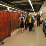 Penn College President Davie Jane Gilmour (left) walks with Secretary Manderino and others alongside the robotic welding stations.