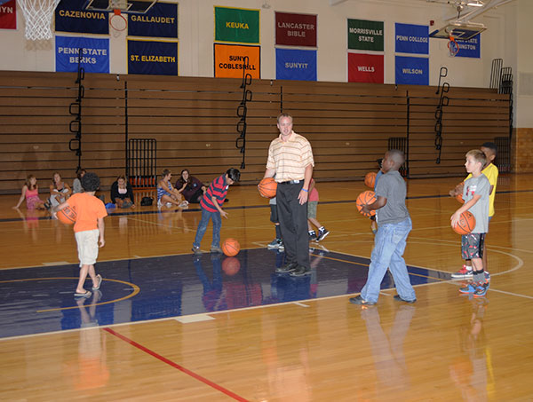 With seemingly boundless spurts of energy, the young guests shoot hoops with Wildcat soccer coach Tyler S. Mensch and (not pictured) Lizze A. Robinholt, secretary/receptionist for athletics.