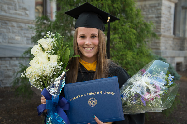 Physician assistant graduate Avery D. Cero enjoys the fragrant rewards of the day. 