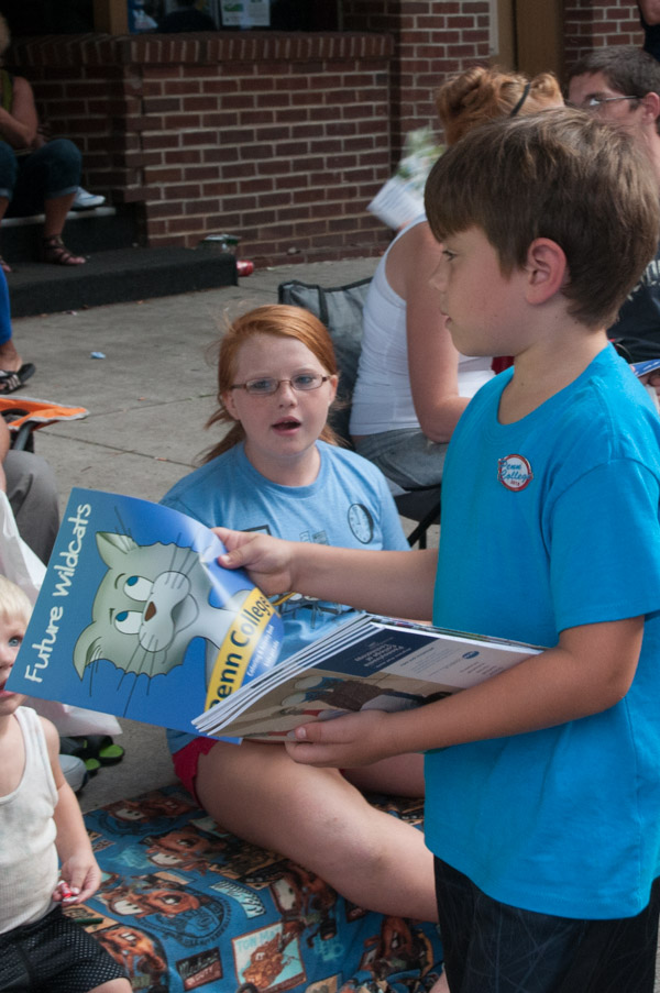 A young Penn College volunteer distributes coloring and activity books.