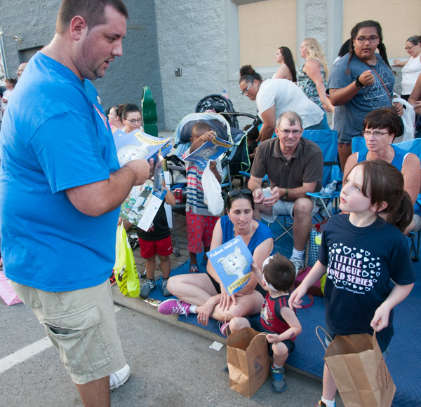 Jeremy R. Bottorf, coordinator of intramural sports and campus recreation, helps to distribute coloring books.