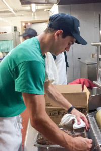 Pennsylvania College of Technology culinary arts and systems student Randall Colby Janowitz, of Westminster, Maryland, works in the kitchen of one of Phillips Seafood’s Ocean City, Maryland, restaurants. Janowitz is completing his second internship with the company, which hired 15 interns from Penn College’s hospitality majors this summer.