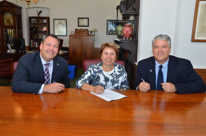 Representatives of Williamson College of the Trades and Pennsylvania College of Technology: from left, Williamson President Michael J. Rounds; Carol A. Lugg, Penn College’s assistant dean of construction and design technology; and Thomas E. Wisneski, Williamson’s vice president of education, sign an articulation agreement that eases the transfer of Williamson graduates to Penn College’s residential construction technology and management bachelor-degree major.