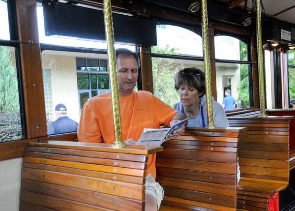 Aboard the trolley, parents thumb through the weekend itinerary.