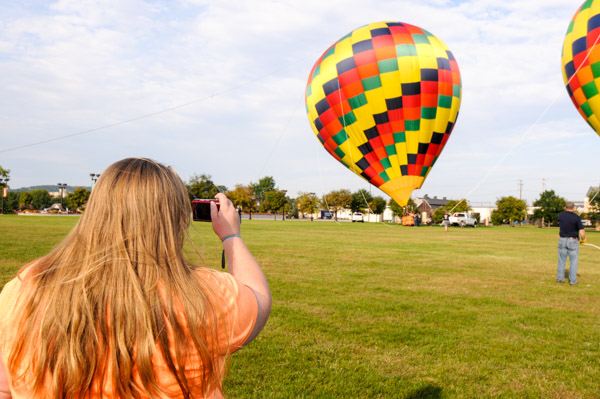 Brittany Evaline Foehlinger of Bainbridge, an applied human services major, photographs balloons on the Madigan Library Lawn.