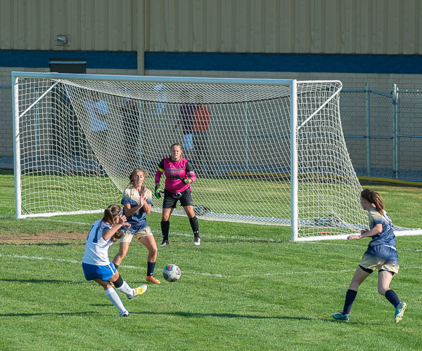 Angela Maniscalco (11) fires a shot in Friday's opening home game of the season.