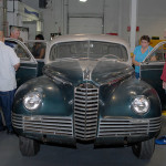 Collision repair instructor Roy H. Klinger (far left) talks about the diagnostic work being performed on the Packard to assess whether a full restoration is warranted.