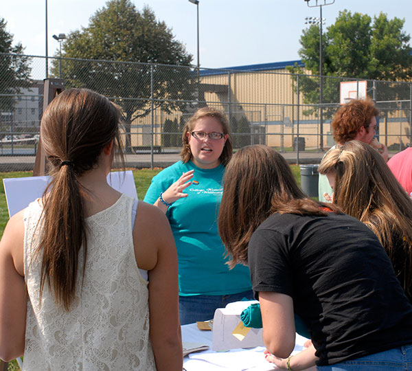 April M. Tucker, of Muncy, an applied human services major, introduces students to College Women of Williamsport.