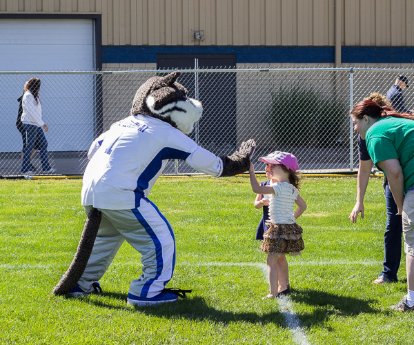 The college mascot engages a young fan ...