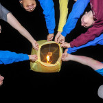 ... launches a lantern with hands-on teamwork.