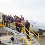 The group pauses for a photo after departing the 727. Joining college and Senate personnel was Christopher A. Logue (fourth from left), chair of the Williamsport Municipal Airport Authority.