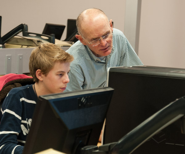 Bill West, assistant professor of electronics, lends a helping hand in an “Electronics Engineering Software Tools” session led by Mark A. Rice, instructor of electronics.